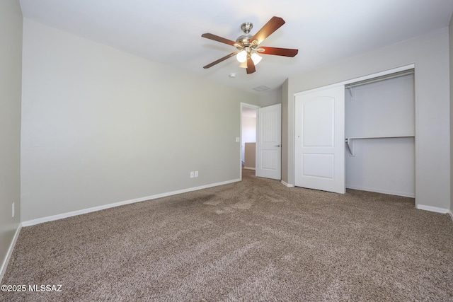 unfurnished bedroom featuring baseboards, carpet flooring, and a closet