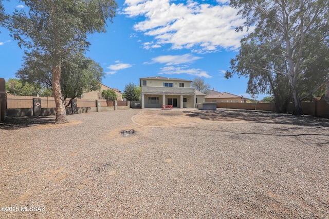 view of front of home with a fenced backyard, driveway, and a garage