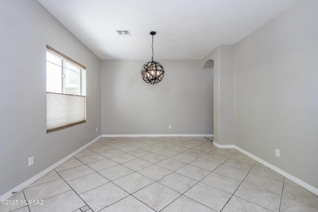 unfurnished room with baseboards, visible vents, a chandelier, and light tile patterned floors