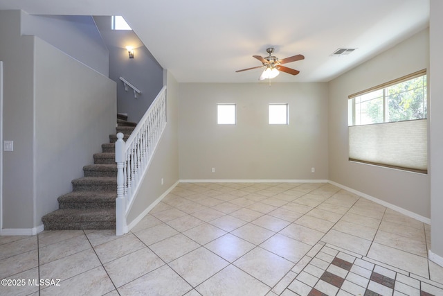 unfurnished room with stairway, ceiling fan, visible vents, and light tile patterned floors