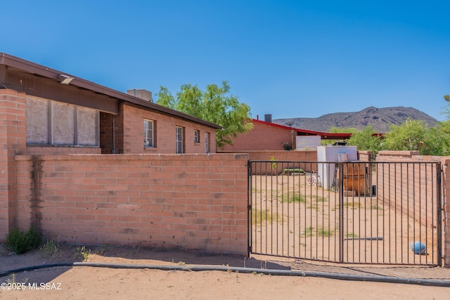 view of gate featuring fence and a mountain view