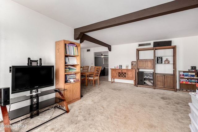 living area with carpet flooring, beam ceiling, ceiling fan, and visible vents