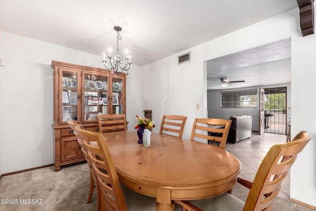dining area featuring light tile patterned floors, ceiling fan with notable chandelier, baseboards, visible vents, and light carpet