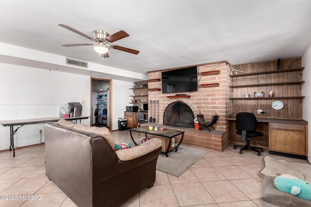 living area featuring a ceiling fan, light tile patterned floors, a fireplace, and visible vents