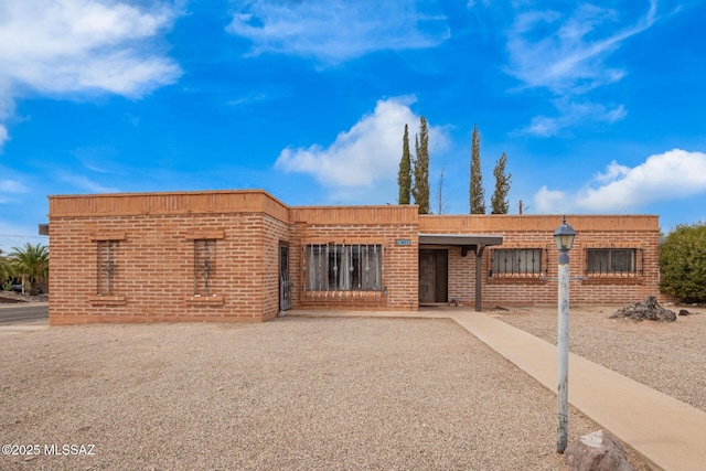 view of front of house featuring brick siding