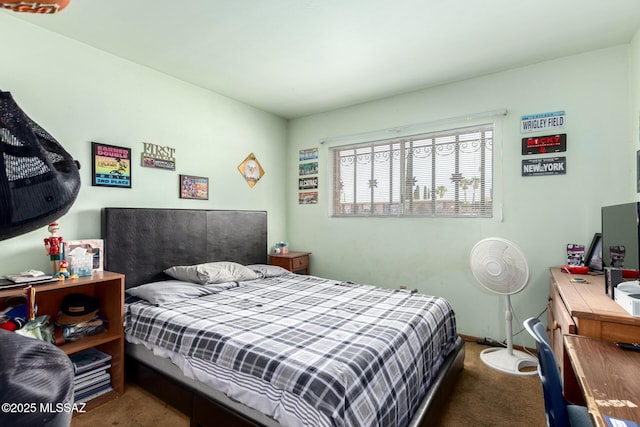 bedroom featuring baseboards and carpet