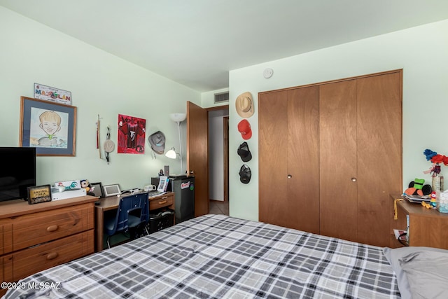 bedroom with visible vents and a closet
