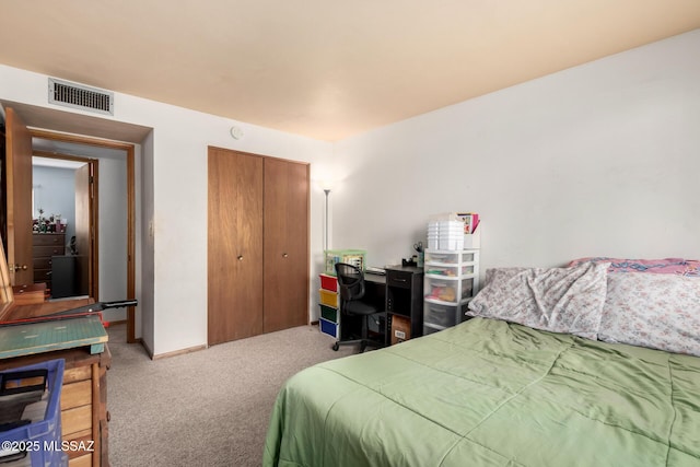 carpeted bedroom with a closet and visible vents