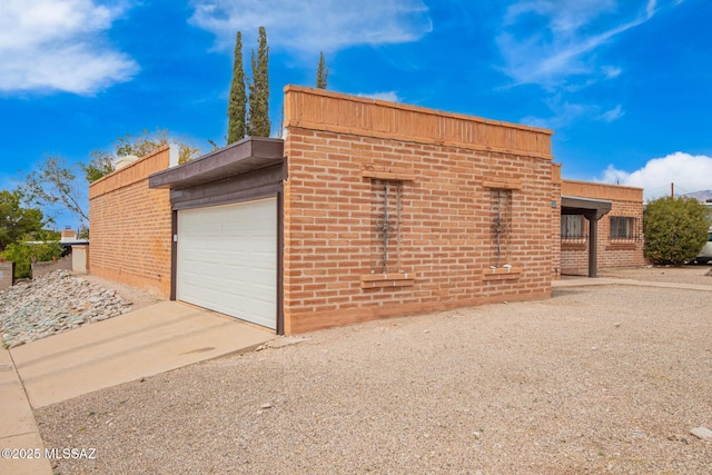 garage featuring concrete driveway