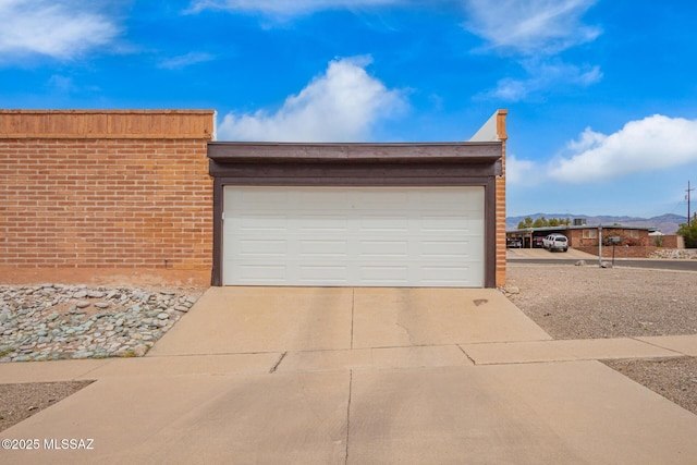garage with concrete driveway