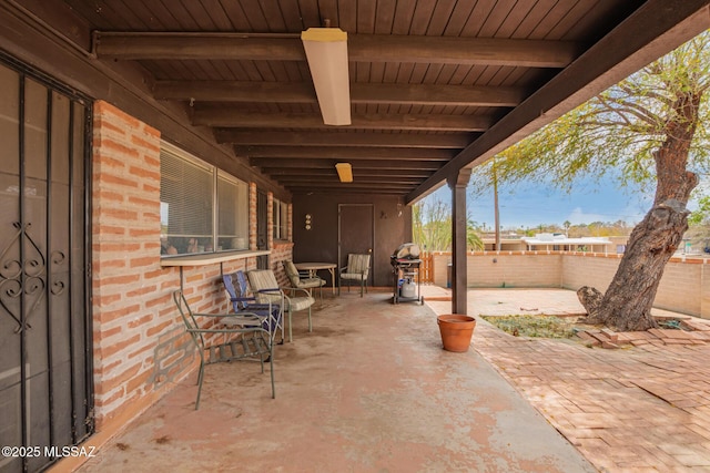 view of patio / terrace with area for grilling and fence