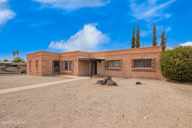 single story home featuring brick siding