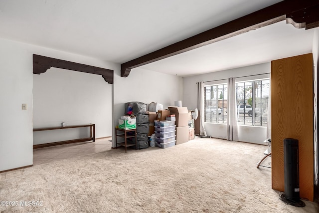 interior space with beamed ceiling and carpet flooring