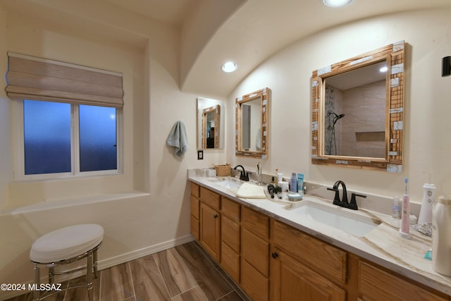 875 S Corte Monte Cristo, Green Valley, AZ 85614 - full bath with a sink, a tile shower, double vanity, and baseboards