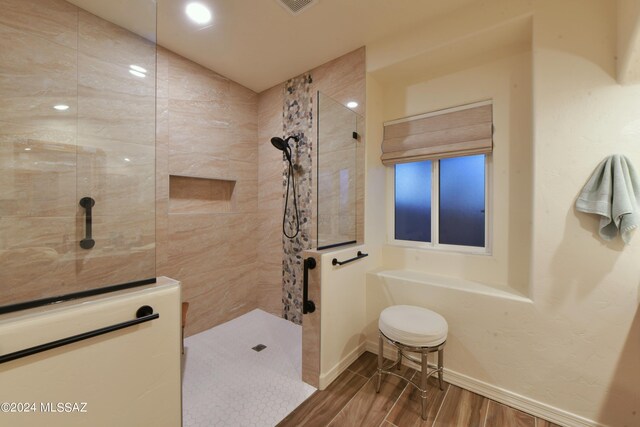 875 S Corte Monte Cristo, Green Valley, AZ 85614 - full bathroom featuring visible vents, baseboards, walk in shower, and wood finished floors