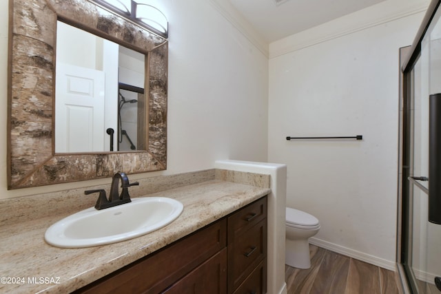 875 S Corte Monte Cristo, Green Valley, AZ 85614 - bathroom with baseboards, toilet, an enclosed shower, vanity, and wood finished floors
