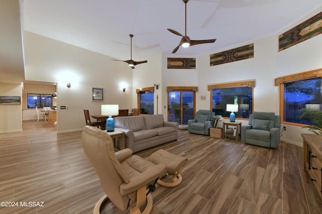 875 S Corte Monte Cristo, Green Valley, AZ 85614 - living room featuring wood finished floors, a towering ceiling, a ceiling fan, and baseboards
