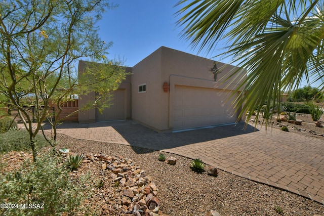 875 S Corte Monte Cristo, Green Valley, AZ 85614 - view of side of property with an attached garage and stucco siding