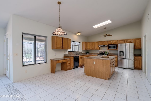 kitchen featuring a center island, under cabinet range hood, stainless steel appliances, decorative light fixtures, and brown cabinets
