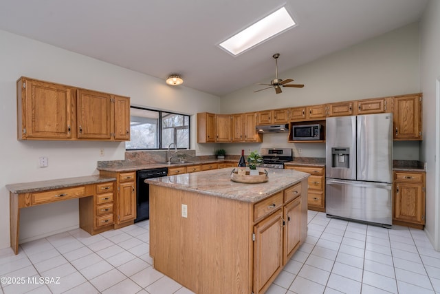 kitchen featuring stainless steel appliances, under cabinet range hood, light tile patterned flooring, and a kitchen island