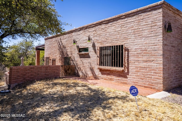 back of property featuring fence