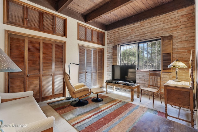 living area with beam ceiling and wood ceiling