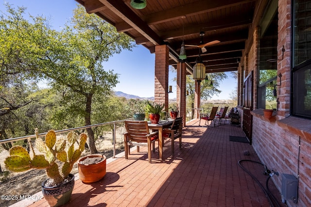 deck featuring a mountain view and outdoor dining space