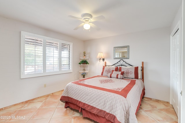 bedroom featuring tile patterned floors, a ceiling fan, and a closet
