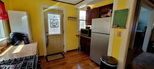 kitchen with light countertops, appliances with stainless steel finishes, baseboards, and dark wood-type flooring