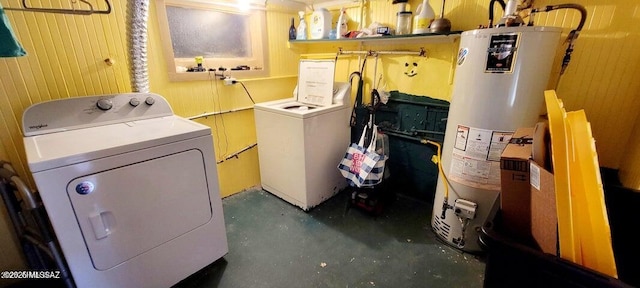 washroom featuring gas water heater, laundry area, separate washer and dryer, and wooden walls