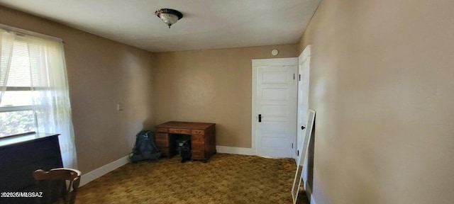 interior space with carpet and baseboards