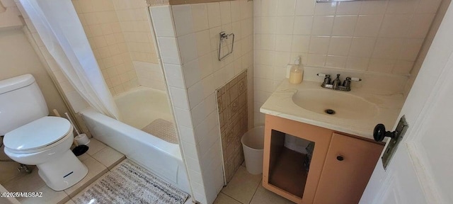 full bathroom featuring tile patterned floors, toilet, vanity, and tile walls