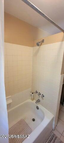full bath featuring shower / tub combination and tile patterned flooring