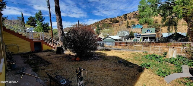 view of yard with fence and stairway