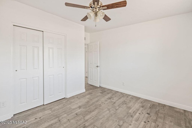 unfurnished bedroom with light wood-style flooring, baseboards, a closet, and ceiling fan