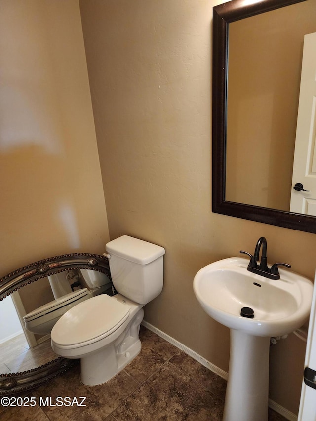 339 W Calle Las Tunas, Sahuarita, AZ 85629 - bathroom with toilet, baseboards, and a baseboard radiator