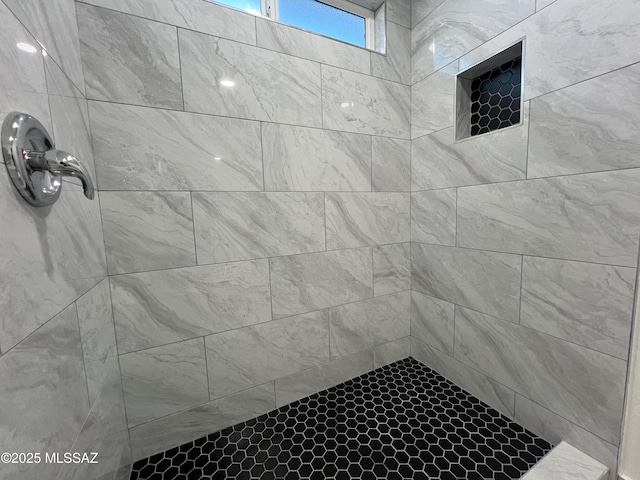 full bath with a tile shower