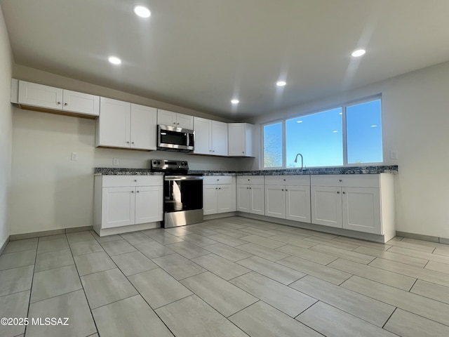 kitchen featuring white cabinetry, recessed lighting, and appliances with stainless steel finishes