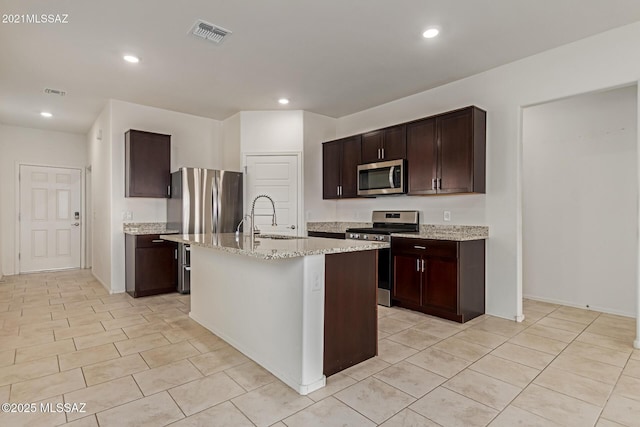 kitchen featuring visible vents, recessed lighting, dark brown cabinets, appliances with stainless steel finishes, and a sink