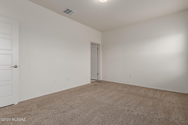 carpeted empty room featuring baseboards and visible vents