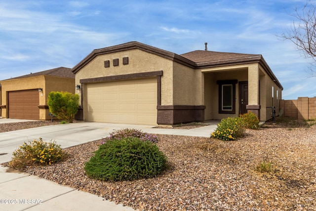 ranch-style home featuring stucco siding, a garage, concrete driveway, and fence