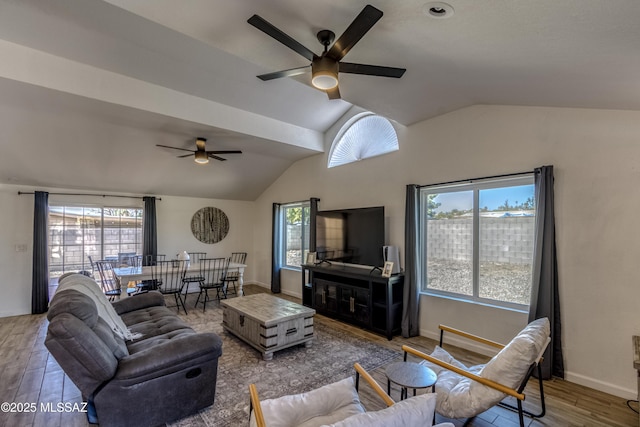 living room featuring baseboards, lofted ceiling, ceiling fan, and wood finished floors