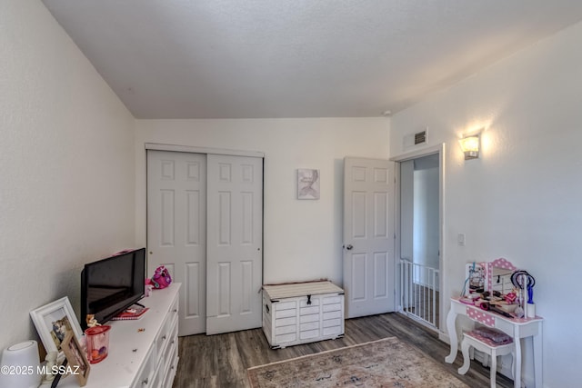 rec room featuring visible vents, lofted ceiling, and wood finished floors