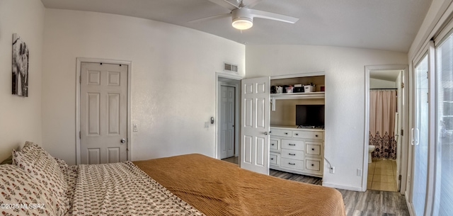 bedroom with visible vents, wood finished floors, ceiling fan, and vaulted ceiling