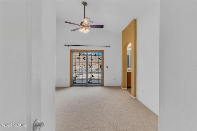 660 W Via Rosaldo, Green Valley, AZ 85614 - spare room with arched walkways, carpet, vaulted ceiling, and a ceiling fan