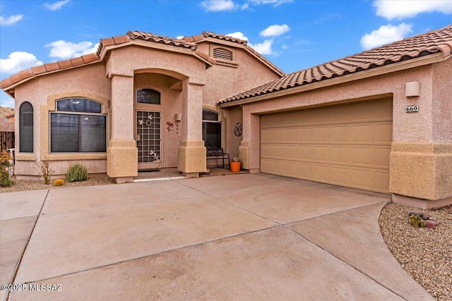 660 W Via Rosaldo, Green Valley, AZ 85614 - mediterranean / spanish-style home with stucco siding, concrete driveway, a garage, and a tile roof