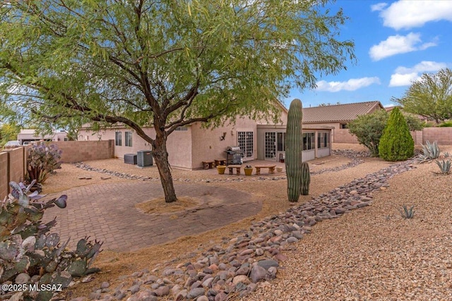 660 W Via Rosaldo, Green Valley, AZ 85614 - back of property with central AC unit, fence, a patio, and stucco siding