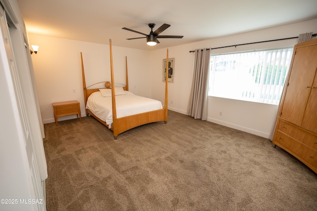 carpeted bedroom featuring baseboards and ceiling fan