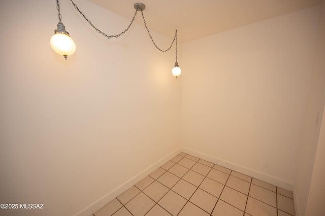 unfurnished room with baseboards and light tile patterned floors