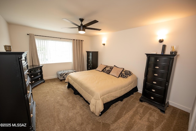 carpeted bedroom with a ceiling fan and baseboards
